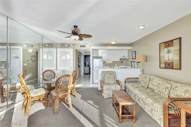 carpeted living room featuring ceiling fan