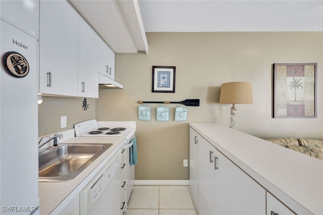 kitchen featuring light tile patterned floors, white appliances, white cabinetry, and sink