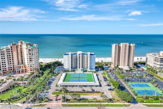 birds eye view of property with a water view and a view of the beach