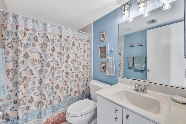 bathroom featuring vanity, curtained shower, and toilet