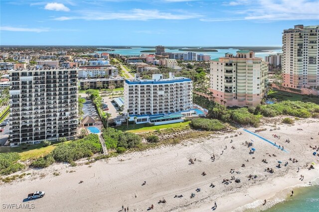 birds eye view of property with a water view and a view of the beach