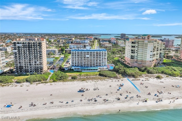 bird's eye view with a water view and a beach view