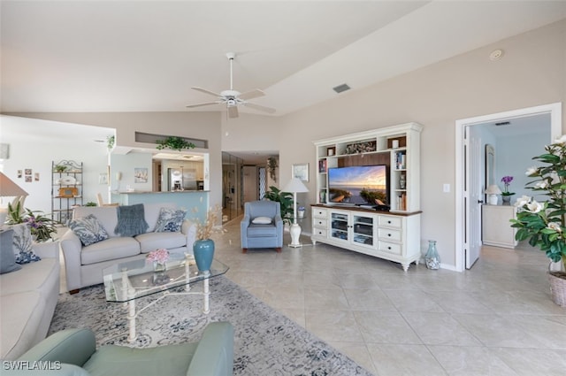 tiled living room with ceiling fan and lofted ceiling