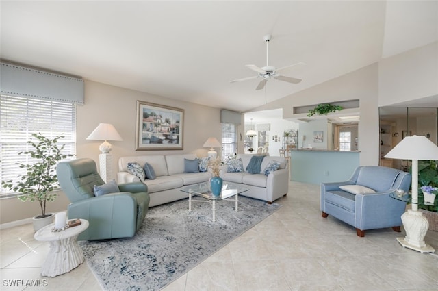 living room with ceiling fan, light tile patterned floors, and vaulted ceiling