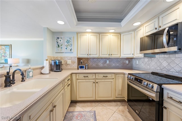 kitchen with stainless steel appliances, tasteful backsplash, ornamental molding, and sink