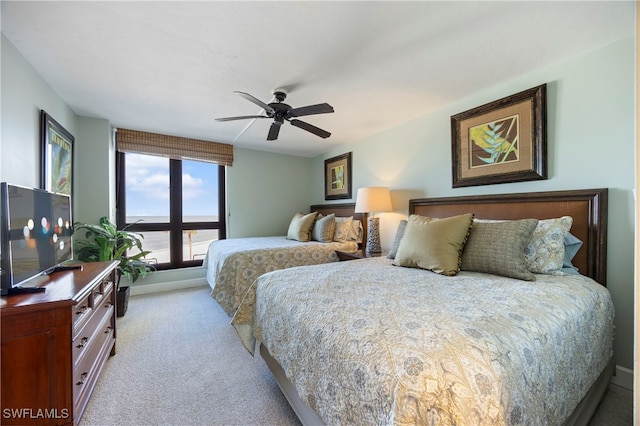 bedroom featuring ceiling fan and light colored carpet