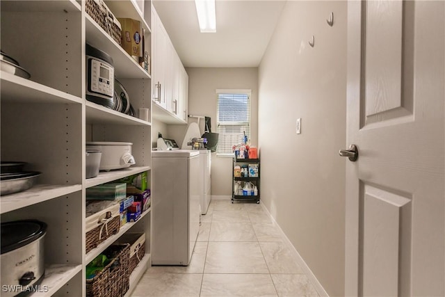 laundry room with independent washer and dryer and cabinets