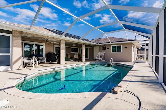 view of pool featuring ceiling fan, a lanai, and a patio