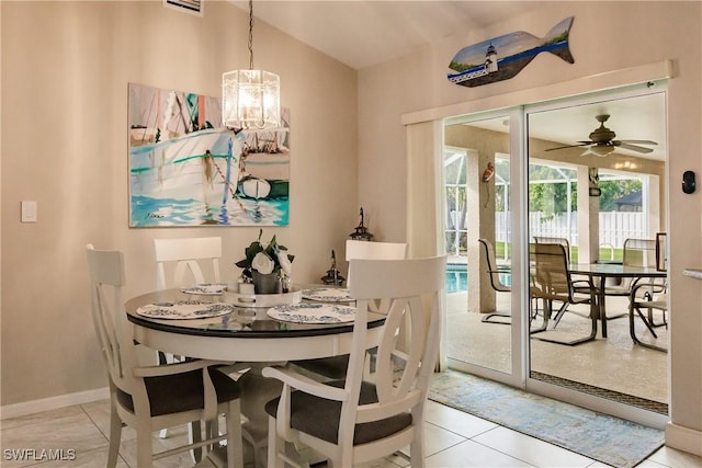 dining space featuring light tile patterned flooring and ceiling fan with notable chandelier