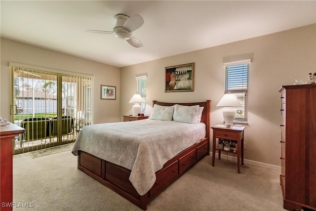 carpeted bedroom featuring ceiling fan, multiple windows, and access to outside