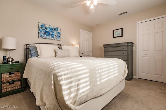 carpeted bedroom featuring ceiling fan and a closet