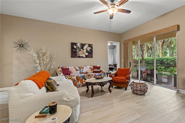 living room with a ceiling fan and light wood-style floors