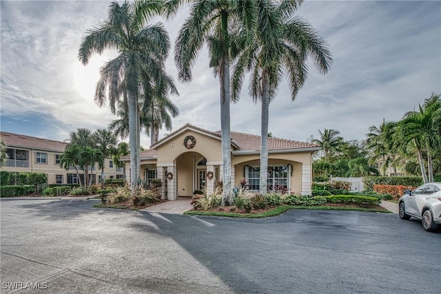 view of front of home with a tile roof and stucco siding