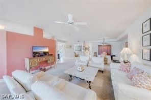 living room featuring carpet flooring and ceiling fan