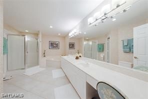 bathroom featuring tile patterned flooring, vanity, and plus walk in shower