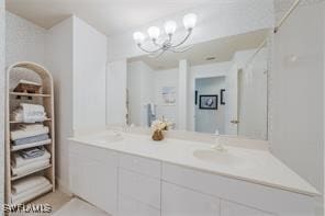 bathroom with vanity and a notable chandelier