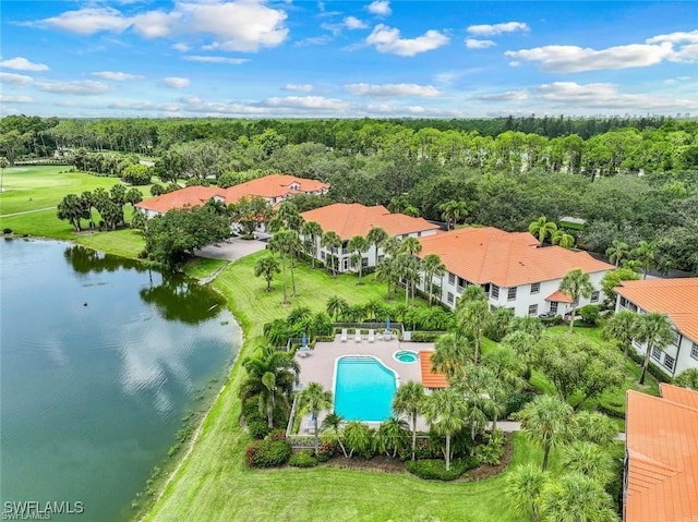 aerial view with a forest view and a water view