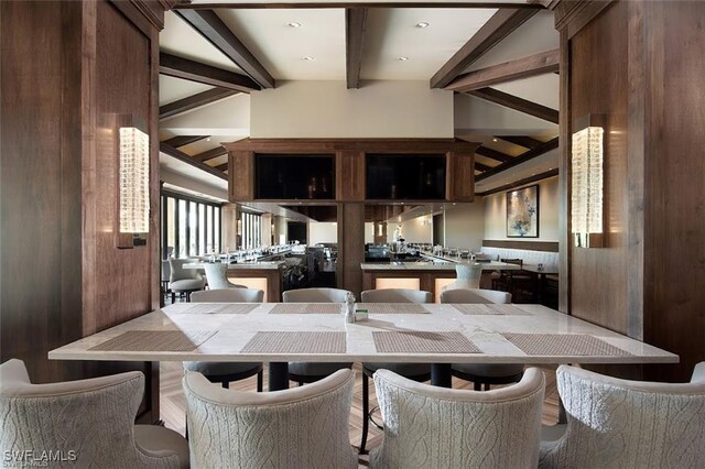 dining area with vaulted ceiling with beams