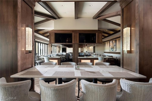 dining room featuring lofted ceiling with beams