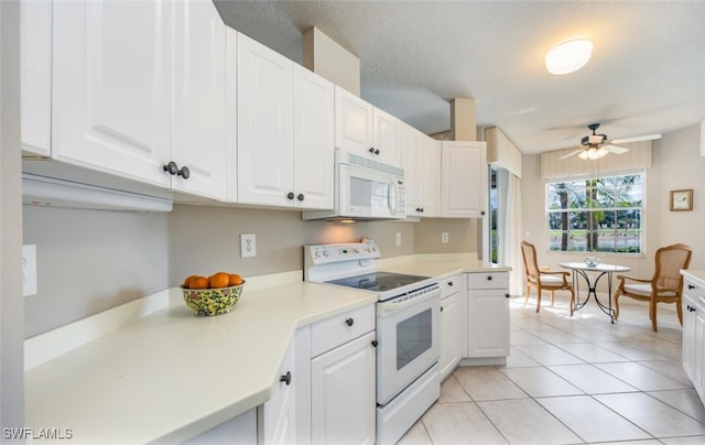 kitchen with white appliances, light tile patterned floors, ceiling fan, light countertops, and white cabinetry