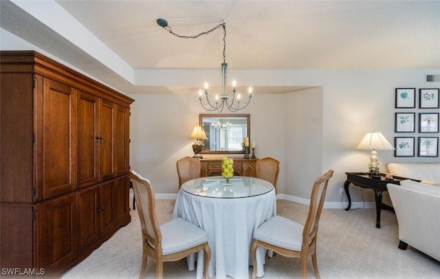 dining area featuring light colored carpet, visible vents, baseboards, and an inviting chandelier