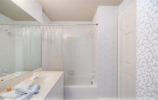 bathroom featuring shower / tub combo with curtain, vanity, and wallpapered walls