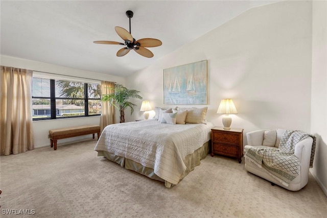 bedroom with ceiling fan, light colored carpet, and vaulted ceiling