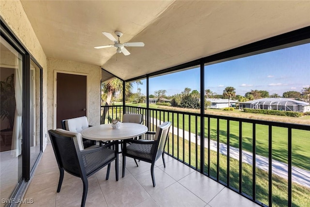 sunroom / solarium featuring ceiling fan