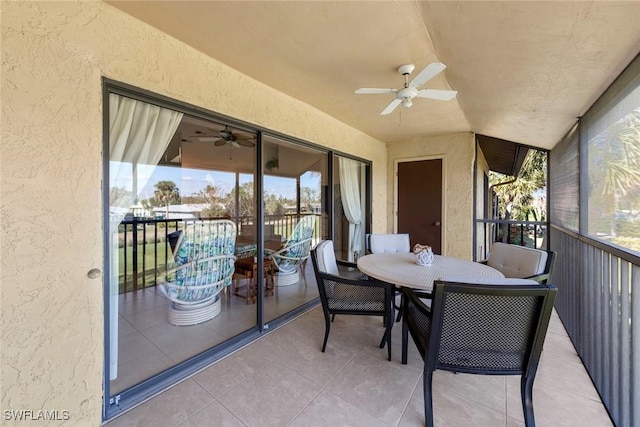 sunroom featuring ceiling fan and vaulted ceiling