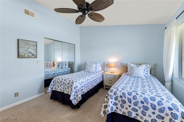 carpeted bedroom with a closet and ceiling fan