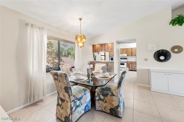 tiled dining room with lofted ceiling and an inviting chandelier