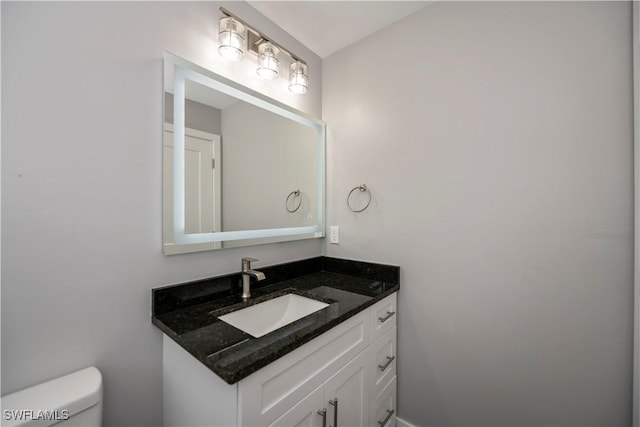 bathroom featuring vanity and toilet