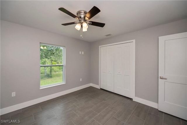 unfurnished bedroom with a closet and ceiling fan