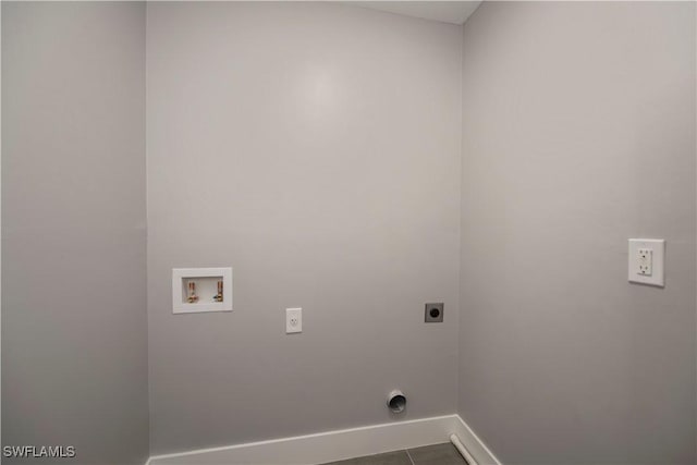 laundry area featuring washer hookup, electric dryer hookup, and dark tile patterned floors