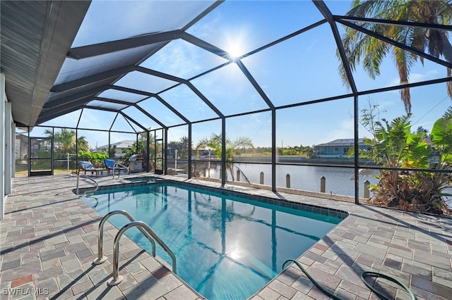 view of swimming pool with a lanai, a water view, and a patio