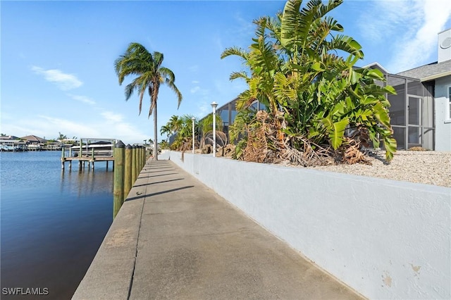 exterior space with a water view and a lanai