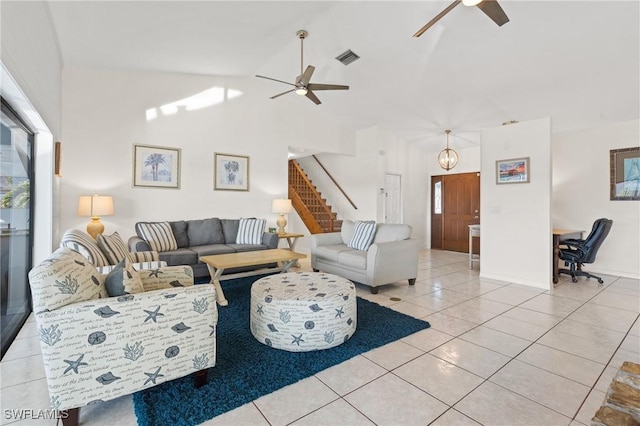 tiled living room with high vaulted ceiling and ceiling fan