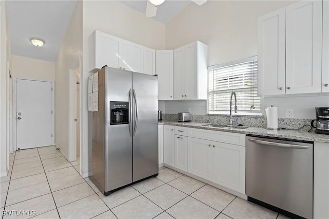 kitchen featuring light stone countertops, appliances with stainless steel finishes, ceiling fan, sink, and white cabinetry