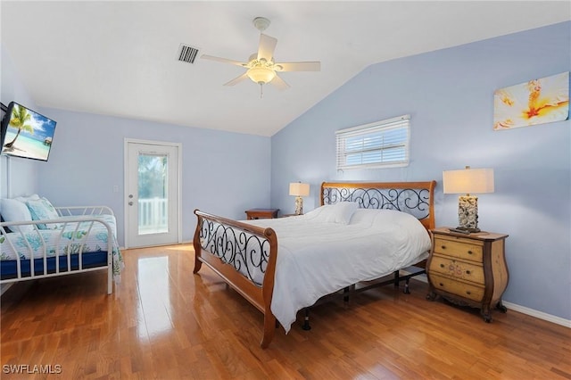 bedroom with hardwood / wood-style flooring, ceiling fan, access to exterior, and lofted ceiling