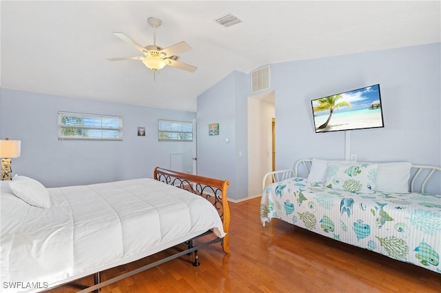 bedroom with hardwood / wood-style floors, vaulted ceiling, and ceiling fan