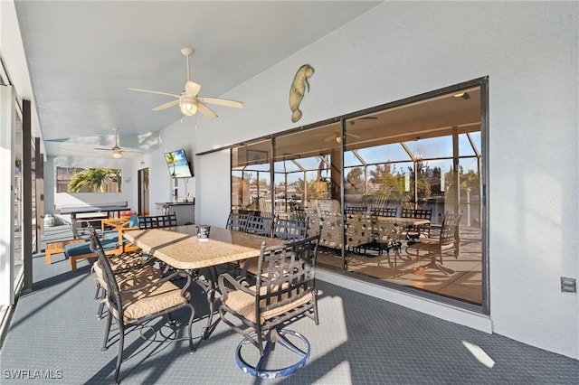 sunroom featuring ceiling fan and vaulted ceiling