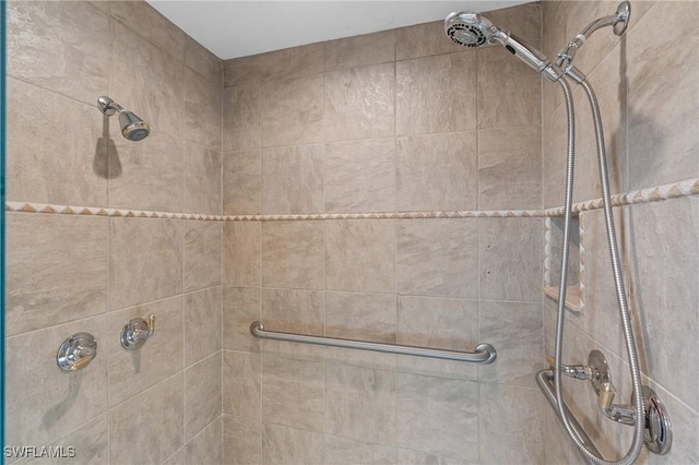 bathroom with a tile shower