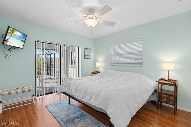 bedroom featuring access to exterior, ceiling fan, and wood-type flooring