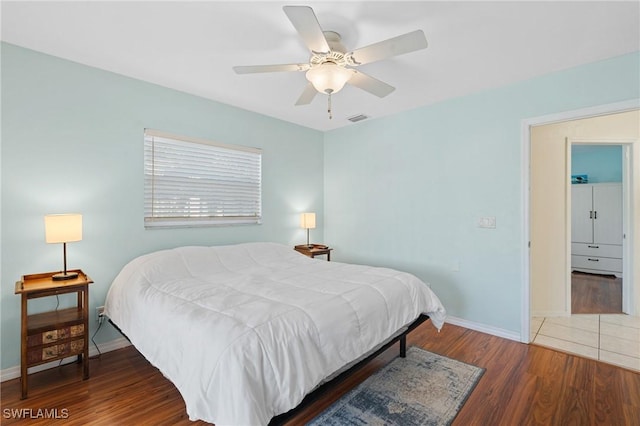 bedroom with ceiling fan and dark hardwood / wood-style floors