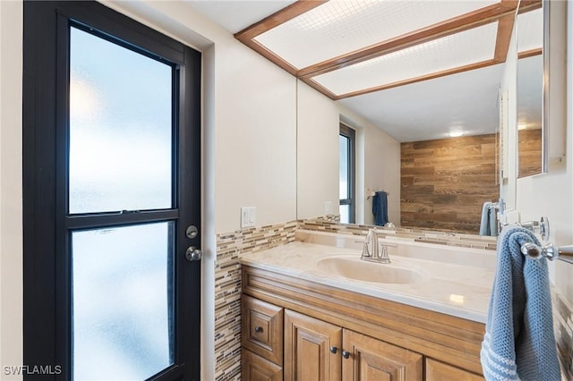 bathroom featuring wood walls and vanity