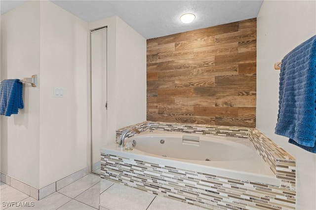 bathroom with tile patterned flooring and tiled bath