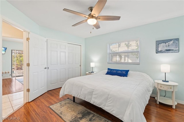 bedroom featuring a closet, hardwood / wood-style flooring, and ceiling fan