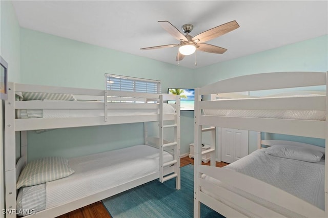 bedroom with ceiling fan and dark hardwood / wood-style floors