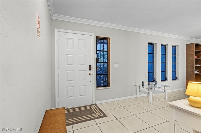 entrance foyer with ornamental molding and light tile patterned floors