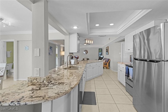 kitchen with kitchen peninsula, appliances with stainless steel finishes, crown molding, sink, and white cabinets